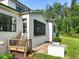 Exterior view of house with screened-in porch, built-in grill, deck with stairs, and manicured landscaping at 1409 Montvale Ridge Dr, Cary, NC 27519