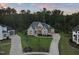 Stately home featuring a three car garage, long driveway and mature landscaping at 1409 Montvale Ridge Dr, Cary, NC 27519