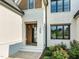 Exterior shot of the home's front facade featuring painted brick, dark trim, and a stone porch at 1409 Montvale Ridge Dr, Cary, NC 27519