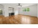 Living room with hardwood floors, a ceiling fan, custom shelving and a beverage cooler at 1409 Montvale Ridge Dr, Cary, NC 27519