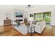 Open-concept living room with hardwood floors, stone fireplace, neutral decor, and sliding doors to an outdoor patio at 1409 Montvale Ridge Dr, Cary, NC 27519