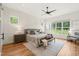 Spacious main bedroom with decorative wall, hardwood floors, a ceiling fan, and large bright windows at 1409 Montvale Ridge Dr, Cary, NC 27519