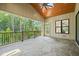 This covered patio boasts stone floors, wood paneled ceiling, and open views of the surrounding wooded landscape at 1409 Montvale Ridge Dr, Cary, NC 27519
