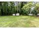 Expansive backyard with lush greenery, sheds, and an RV perfect for outdoor enjoyment at 141 Weston Rd, Garner, NC 27529