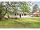 Well maintained backyard with lush green grass and a white sided house at 141 Weston Rd, Garner, NC 27529