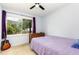 This bedroom features a large window, wood dresser, and a guitar leaning against the wall at 141 Weston Rd, Garner, NC 27529