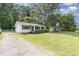 Delightful home with well-kept lawn, a gravel driveway, and mature trees at 141 Weston Rd, Garner, NC 27529