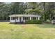Charming one-story home with a well-maintained lawn, mature trees, and curb appeal at 141 Weston Rd, Garner, NC 27529