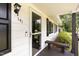 Inviting front porch with bench seating, a security door, and updated exterior fixtures at 141 Weston Rd, Garner, NC 27529