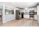 Bright, updated kitchen with stainless steel appliances, white cabinets, and modern flooring at 141 Weston Rd, Garner, NC 27529