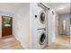 Convenient laundry area with stacked washer and dryer units and an adjacent barn door at 141 Weston Rd, Garner, NC 27529