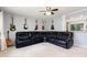 Spacious living room featuring an oversized leather sectional and unique guitar wall decor at 141 Weston Rd, Garner, NC 27529
