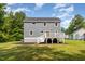 Exterior view of the home, featuring a backyard and a wooden deck at 1605 Bobwhite Ln, Rocky Mount, NC 27804