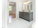 Bathroom featuring a modern double sink vanity with an open door leading to a room with natural light at 1605 Bobwhite Ln, Rocky Mount, NC 27804