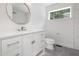 Bright bathroom featuring a modern vanity, round mirror, and stylish toilet near tiled shower at 1605 Bobwhite Ln, Rocky Mount, NC 27804