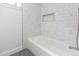 Tiled bathroom featuring a white bath tub and wall mounted shower fixture at 1605 Bobwhite Ln, Rocky Mount, NC 27804