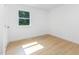 Bright bedroom with hardwood floors, white walls, window with view to trees, and trim at 1605 Bobwhite Ln, Rocky Mount, NC 27804