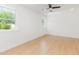 Bright, empty bedroom with light wood floors, a ceiling fan and big windows with outside view at 1605 Bobwhite Ln, Rocky Mount, NC 27804