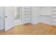 Bright walk-in closet with custom shelving and an open door to the bathroom featuring marble floors at 1605 Bobwhite Ln, Rocky Mount, NC 27804