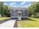 Charming two-story home with gray siding, a concrete driveway and a welcoming front porch at 1605 Bobwhite Ln, Rocky Mount, NC 27804