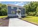Charming two-story home with gray siding, a concrete driveway and a welcoming front porch at 1605 Bobwhite Ln, Rocky Mount, NC 27804