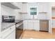 Well-lit kitchen with granite countertops, stainless appliances, and white subway tile backsplash at 1605 Bobwhite Ln, Rocky Mount, NC 27804