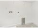 Well-lit laundry room with utility connections and shelving perfect for organizing at 1605 Bobwhite Ln, Rocky Mount, NC 27804