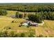 A sprawling estate featuring a sparkling pool, equestrian facilities, and lush green fields at 1625 Haystack Ln, Burlington, NC 27217