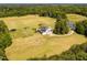 Lush estate featuring a main house, private pond, and expansive pastures, set amidst mature trees at 1625 Haystack Ln, Burlington, NC 27217