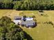 Stunning aerial view showcasing the estate's pool, outbuildings, and expansive fenced pastures at 1625 Haystack Ln, Burlington, NC 27217