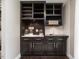 Chic bar area featuring dark cabinets, marble countertops, and subway tile backsplash at 1625 Haystack Ln, Burlington, NC 27217