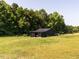 Charming black barn and adjacent pasture provides a tranquil space for animals to graze freely at 1625 Haystack Ln, Burlington, NC 27217