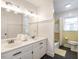 Bright bathroom features double vanity, updated fixtures, and a bathtub with yellow tiling at 1625 Haystack Ln, Burlington, NC 27217