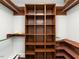 Walk-in closet with custom wood shelving and ample storage space at 1625 Haystack Ln, Burlington, NC 27217