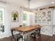 Elegant dining room featuring hardwood floors, stylish lighting, and a charming china cabinet at 1625 Haystack Ln, Burlington, NC 27217