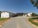 Charming farmhouse with a gravel driveway, black metal roof and an abundance of parking at 1625 Haystack Ln, Burlington, NC 27217