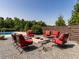 Backyard patio with cozy fire pit surrounded by plush seating and a privacy fence at 1625 Haystack Ln, Burlington, NC 27217