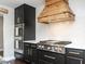 This modern kitchen features stainless steel appliances, custom range hood, and white subway tile backsplash at 1625 Haystack Ln, Burlington, NC 27217