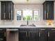 Well-appointed kitchen featuring dark cabinetry, modern fixtures, and ample counter space at 1625 Haystack Ln, Burlington, NC 27217