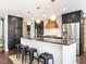 Stylish kitchen features a spacious island with barstools, stainless appliances, and custom cabinetry at 1625 Haystack Ln, Burlington, NC 27217