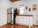Corner kitchenette with stainless steel refrigerator, white cabinets, and rustic wood countertop at 1625 Haystack Ln, Burlington, NC 27217