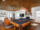 Spacious living room features a pool table, wood ceiling, and lots of natural light at 1625 Haystack Ln, Burlington, NC 27217
