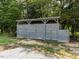 Large privacy shed with double doors for extra storage surrounded by green trees at 1625 Haystack Ln, Burlington, NC 27217