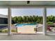 Secluded pool area framed by porch posts, lush greenery, and blue skies at 1625 Haystack Ln, Burlington, NC 27217