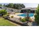 Inviting outdoor pool area with lush landscaping, stone accents, and relaxing seating, ideal for entertaining at 1625 Haystack Ln, Burlington, NC 27217