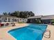 Backyard pool surrounded by lush landscaping and multiple outdoor seating areas at 1625 Haystack Ln, Burlington, NC 27217