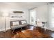 Light-filled sitting room with hardwood floors, modern decor, and two large windows at 1625 Haystack Ln, Burlington, NC 27217