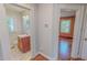 Cozy bathroom featuring a vanity with a wooden cabinet and sink, complemented by a window for natural light at 171 Magnolia Dr, Roxboro, NC 27573