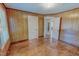 Bedroom with natural wood paneling, trim, and flooring plus access to another room at 171 Magnolia Dr, Roxboro, NC 27573