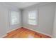 Cozy bedroom with hardwood floors, neutral walls, and natural light streaming through the windows at 171 Magnolia Dr, Roxboro, NC 27573